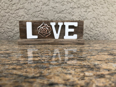 LOVE sign (weathered wood) Weathered Wood LOVE handmade sign with silver rose for the O and LVE white letters. 