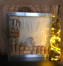 Load image into Gallery viewer, Wine o’clock! PERFECT FOR A WINE BAR...Silver Plastic Shadowbox with natural linen color background.  Wine o’clock! design in Silver Chalkology Ink.  Various wine corks included.  Can Hang or Stand Alone.