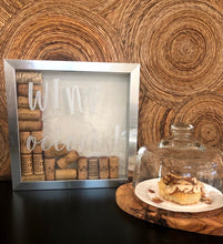 Load image into Gallery viewer, Wine o’clock! PERFECT FOR A WINE BAR...Silver Plastic Shadowbox with natural linen color background.  Wine o’clock! design in Silver Chalkology Ink.  Various wine corks included.  Can Hang or Stand Alone.