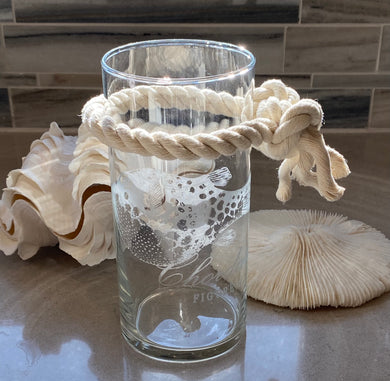 COAS⚓️AL COLLECTION ~ Etched Fish Glass Vase This COAS⚓️AL  COLLECTION cylinder Etched Glass Fish Design Vase (3 1/2” x 6”) is embellished with a cotton knotted rope with frayed ends.  What a unique addition to your Home Décor...add flowers, driftwood pieces or shells